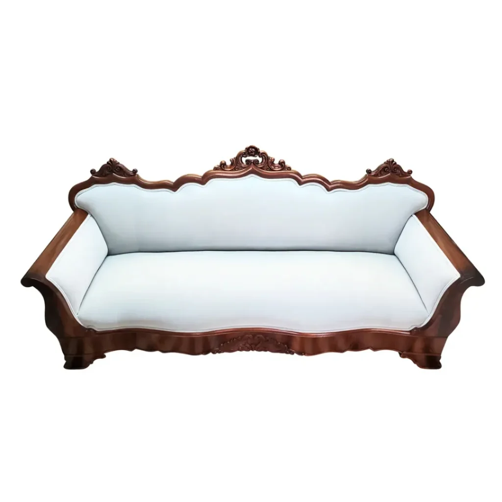 Antique carved sofa upholstered in luxurious baby blue velvet,