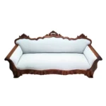 Antique carved sofa upholstered in luxurious baby blue velvet,