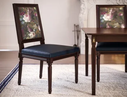 Luxury wooden dining chair featuring decorative floral fabric, carved detailing, and a cushioned faux leather seat.