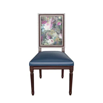 Classic solid wood dining chair with a floral upholstered backrest and black padded seat beside a traditional wooden dining table.