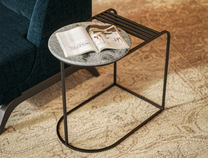 Contemporary C-shaped accent table featuring marble-look tabletop and metal storage rack