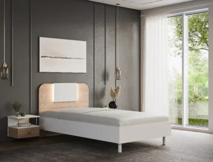 Modern single bed frame with a wooden headboard and white platform base in a contemporary bedroom.