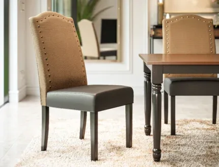 Contemporary upholstered dining chair with a high-back design and nailhead detailing in a stylish dining room setting.