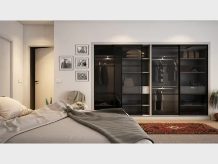Luxury sliding wardrobe featuring smoked glass panels and organized shelving.