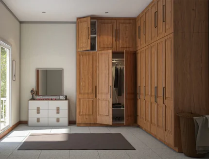 Modern L-shaped wooden wardrobe with overhead cabinets and premium panel detailing.